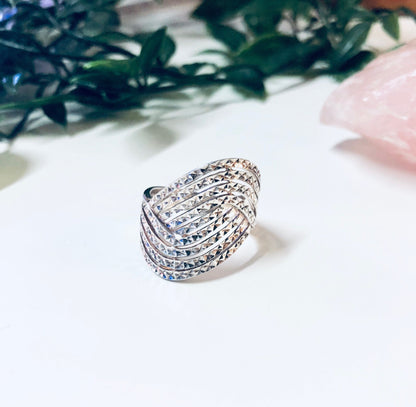 Vintage silver wave design ring crafted in Thailand, 925 sterling silver statement jewelry with sparkling details, unique ring amongst greenery