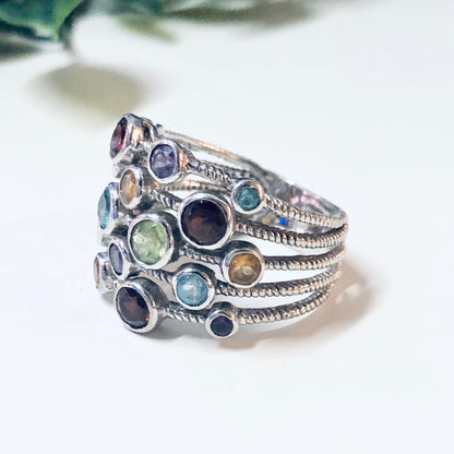 Vintage silver multi-band ring with colorful gemstones including purple, blue, red, green, and yellow stones, creating a bold statement jewelry piece.