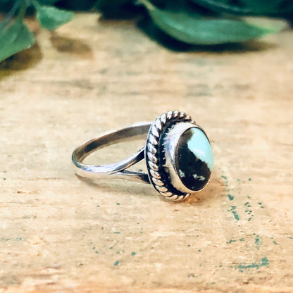 Vintage silver ring with blue and brown cabochon stones on rustic background