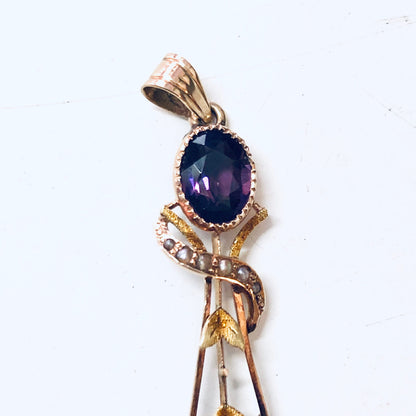 Vintage 14K yellow gold pendant with amethyst stone and pearl accents in a floral design