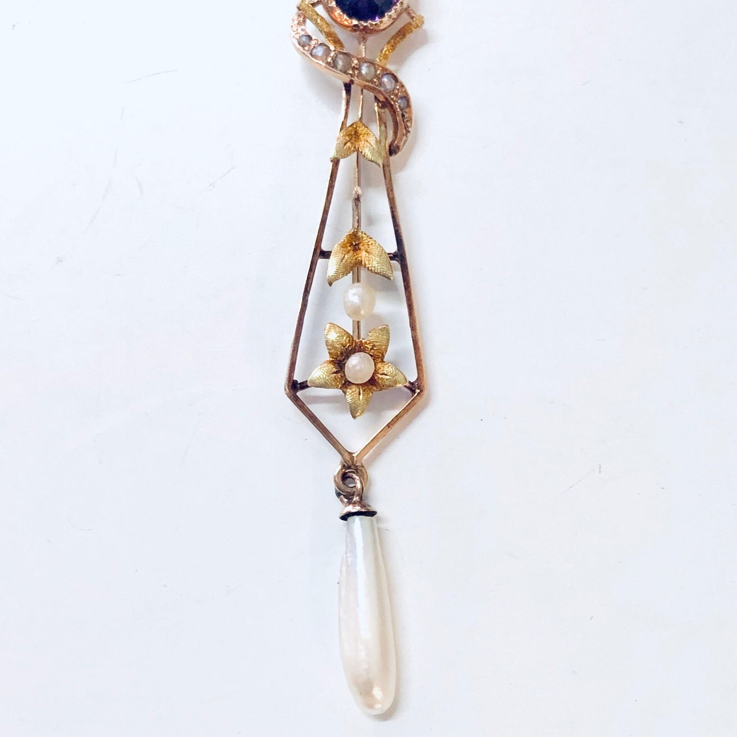 Vintage 14K yellow gold pendant necklace with amethyst stone, pearl drop, and intricate floral design.