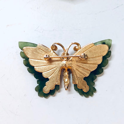 Vintage gold-toned butterfly brooch with faux pearls and green jade accents, decorative pin jewelry from the past.