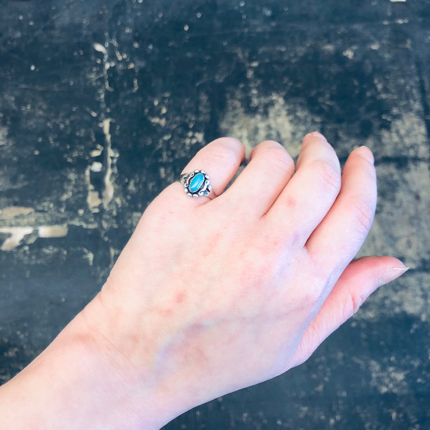 Vintage turquoise and silver pinky ring on hand, bohemian southwestern jewelry style