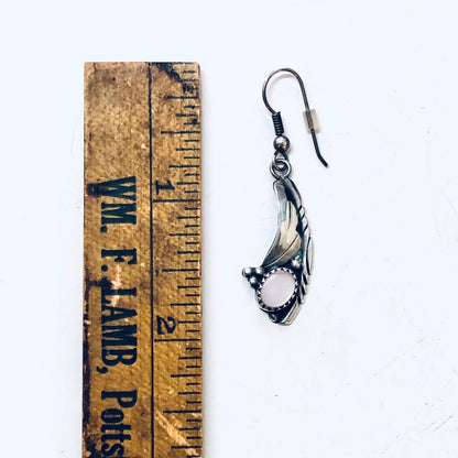 Vintage silver dangle earrings with mother of pearl inlay in Southwestern bohemian style against an antique wooden ruler