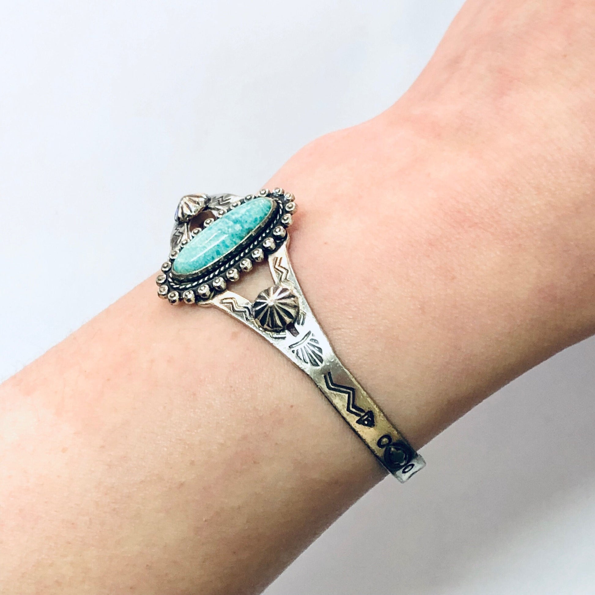 Vintage silver cuff bracelet with turquoise stone and stamped southwestern design