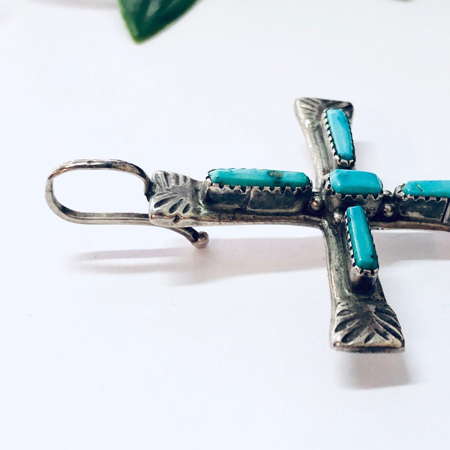 Vintage Zuni silver cross pendant with turquoise inlay, Native American jewelry from the 1970s.