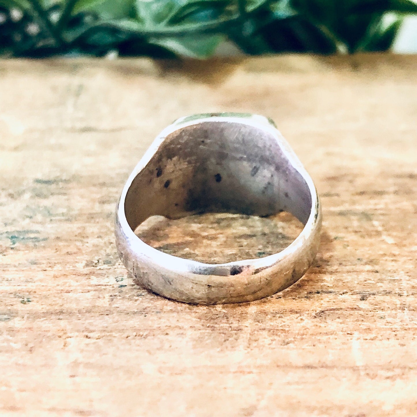 Vintage silver cocktail ring with raw quartz stone on weathered wood surface