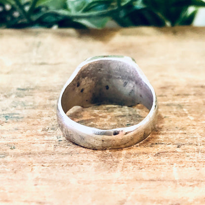 Vintage silver cocktail ring with raw quartz stone on weathered wood surface