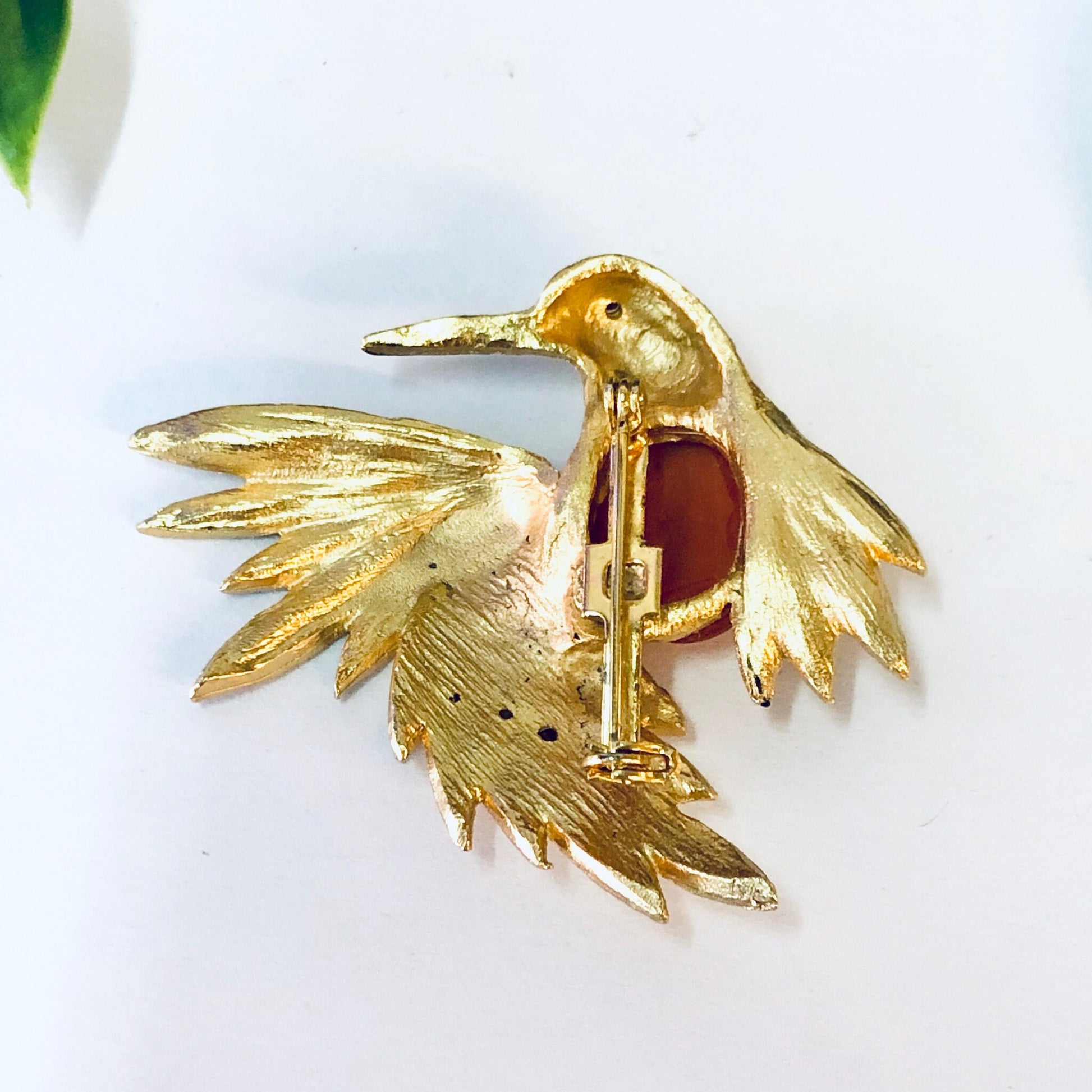 Vintage gold-toned bird brooch pin with orange stone and rhinestone accents