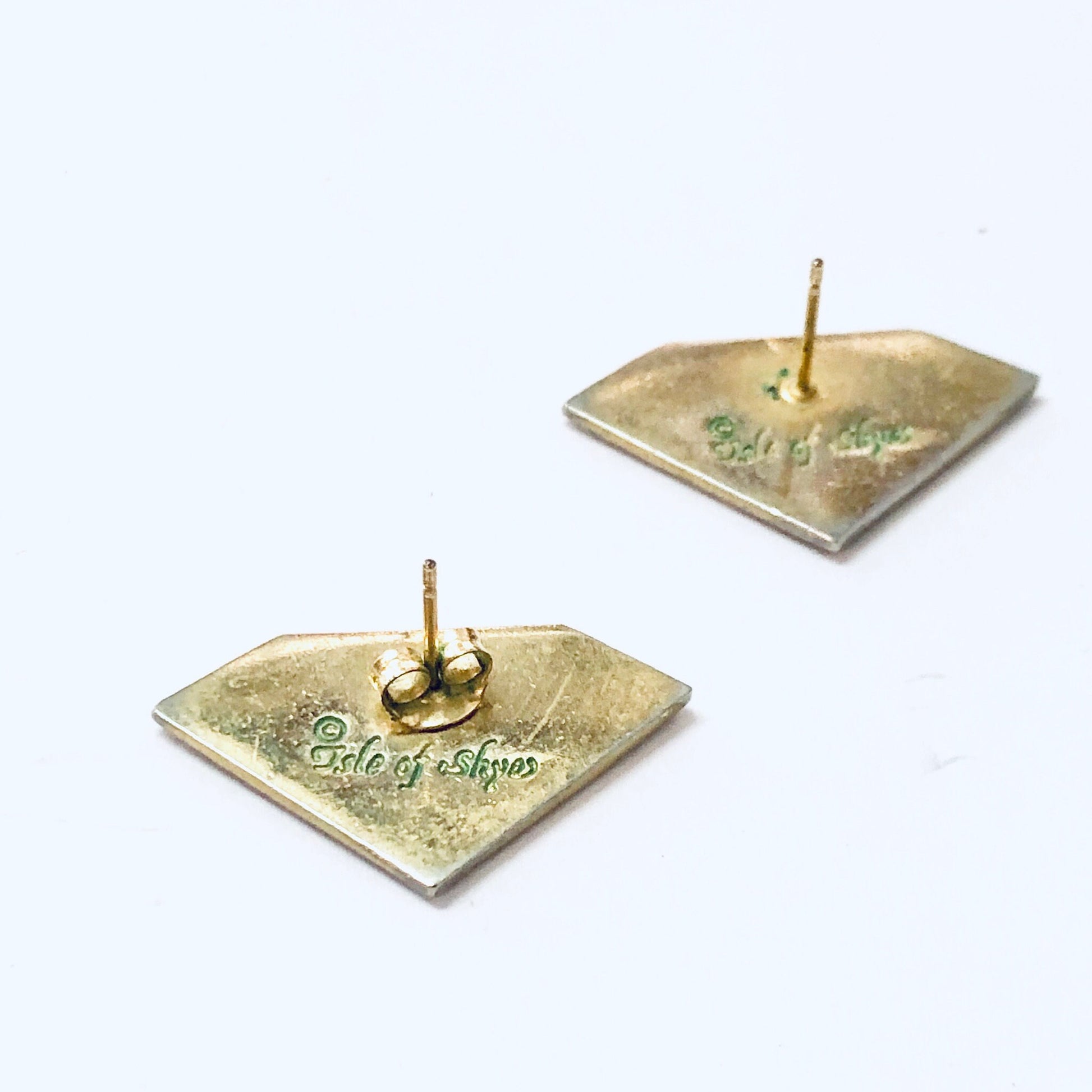 Vintage diamond-shaped souvenir earrings from Isle of Skye with "Isle of Skye" text and green specks, on pierced posts, isolated on white background