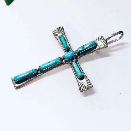 Vintage Zuni silver cross pendant with turquoise inlay, Native American religious jewelry from the southwest United States.