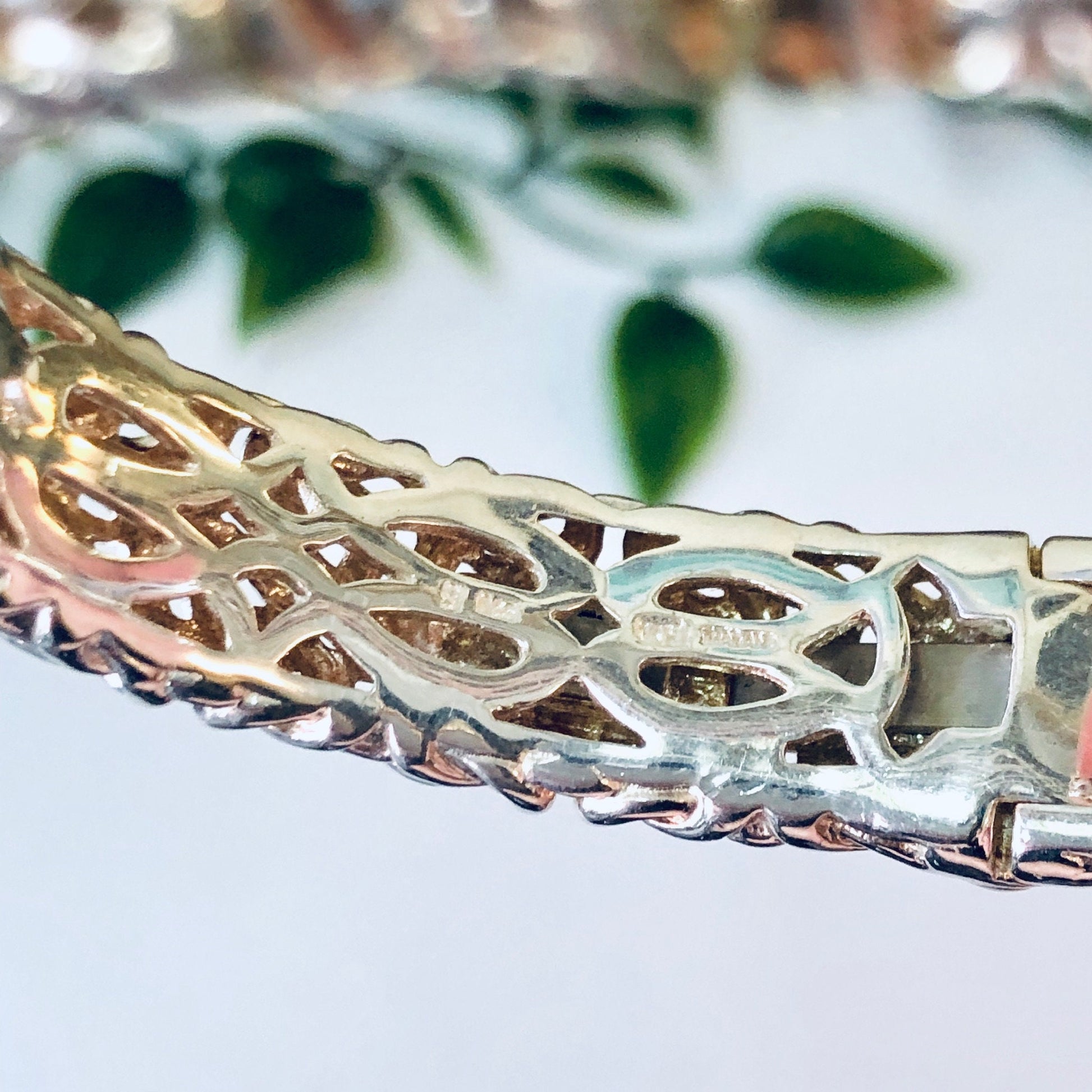 Vintage silver bangle bracelet with gold accents and intricate cutout design, hinged cuff style, unique 925 silver jewelry.