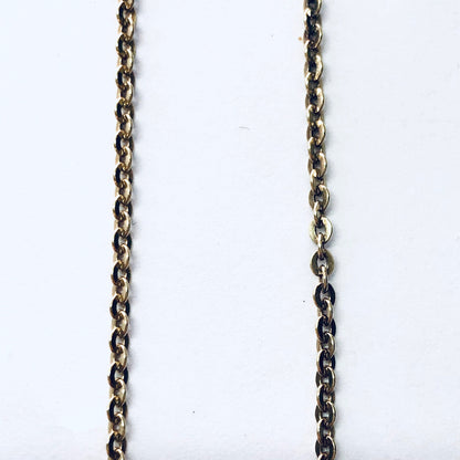 Antique gold metal chain necklace against white background