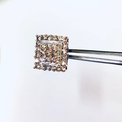 Vintage 10K gold diamond cluster earrings in Art Deco style, square stud design with multiple small diamonds set in gold, held by tweezers against white background.