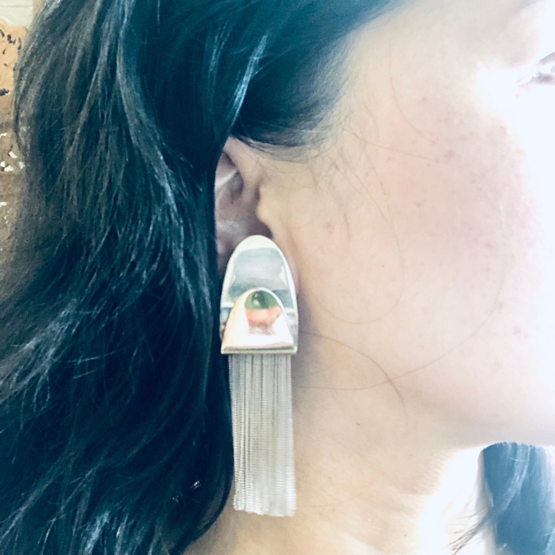 Vintage silver fringe clip-on earrings with unique design, made in Italy from 925 silver, shown on a woman's ear with dark hair.