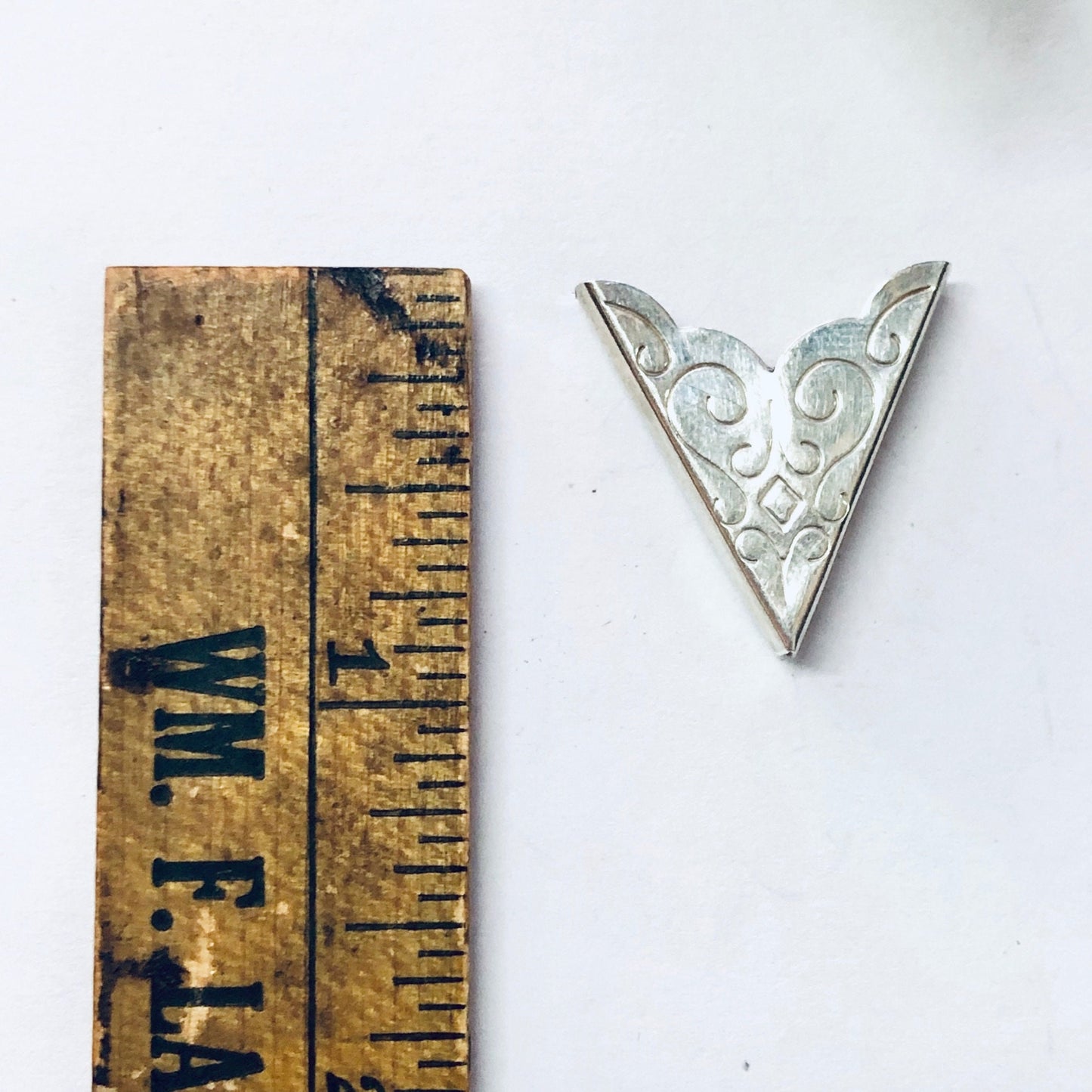 Vintage silver collar tips with swirl design on a wooden ruler, 925 stamped silver accessories for western wear