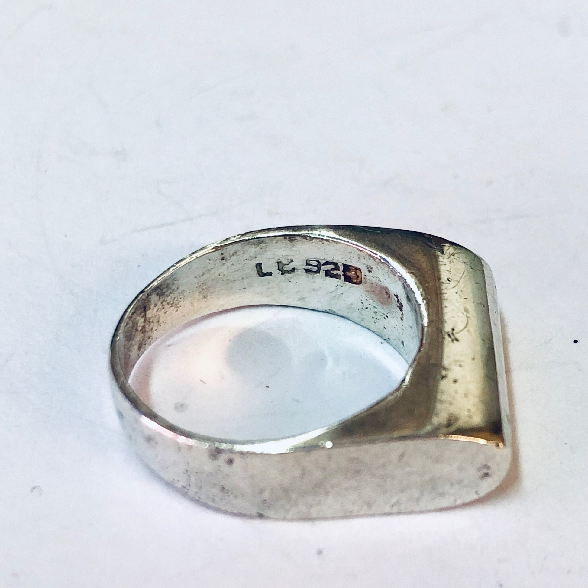 Vintage sterling silver modernist band ring with simple, sleek design and unique shape, showcasing minimalist style jewelry from the past.