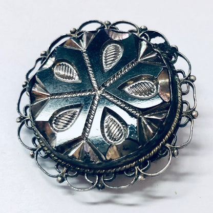 Vintage silver round brooch pendant with intricate leaf design, suitable for necklace or unique jewelry piece, made of 925 silver.