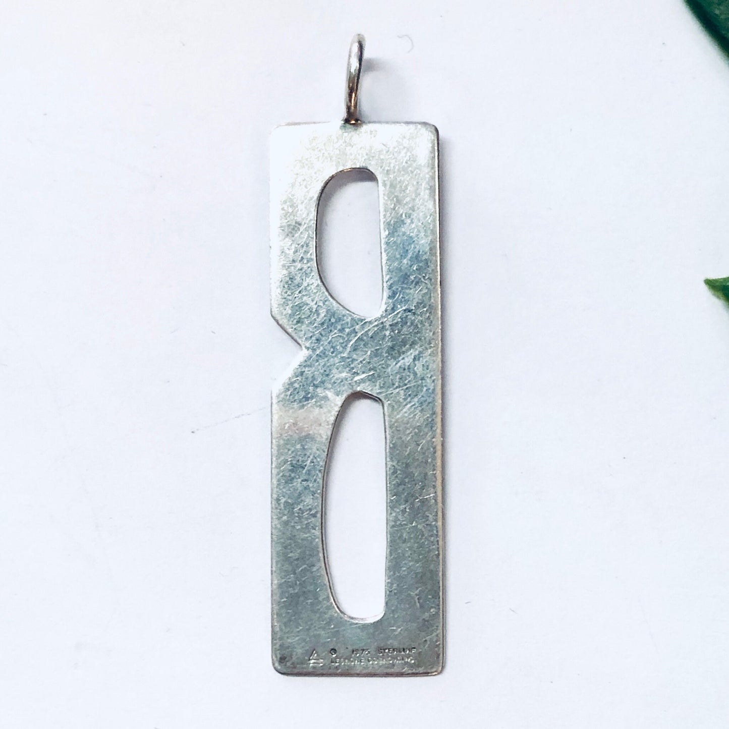 Vintage silver rectangular pendant with cutout letter "B" design, aged patina finish, made by Leonore Doskow, for necklace or charm bracelet.