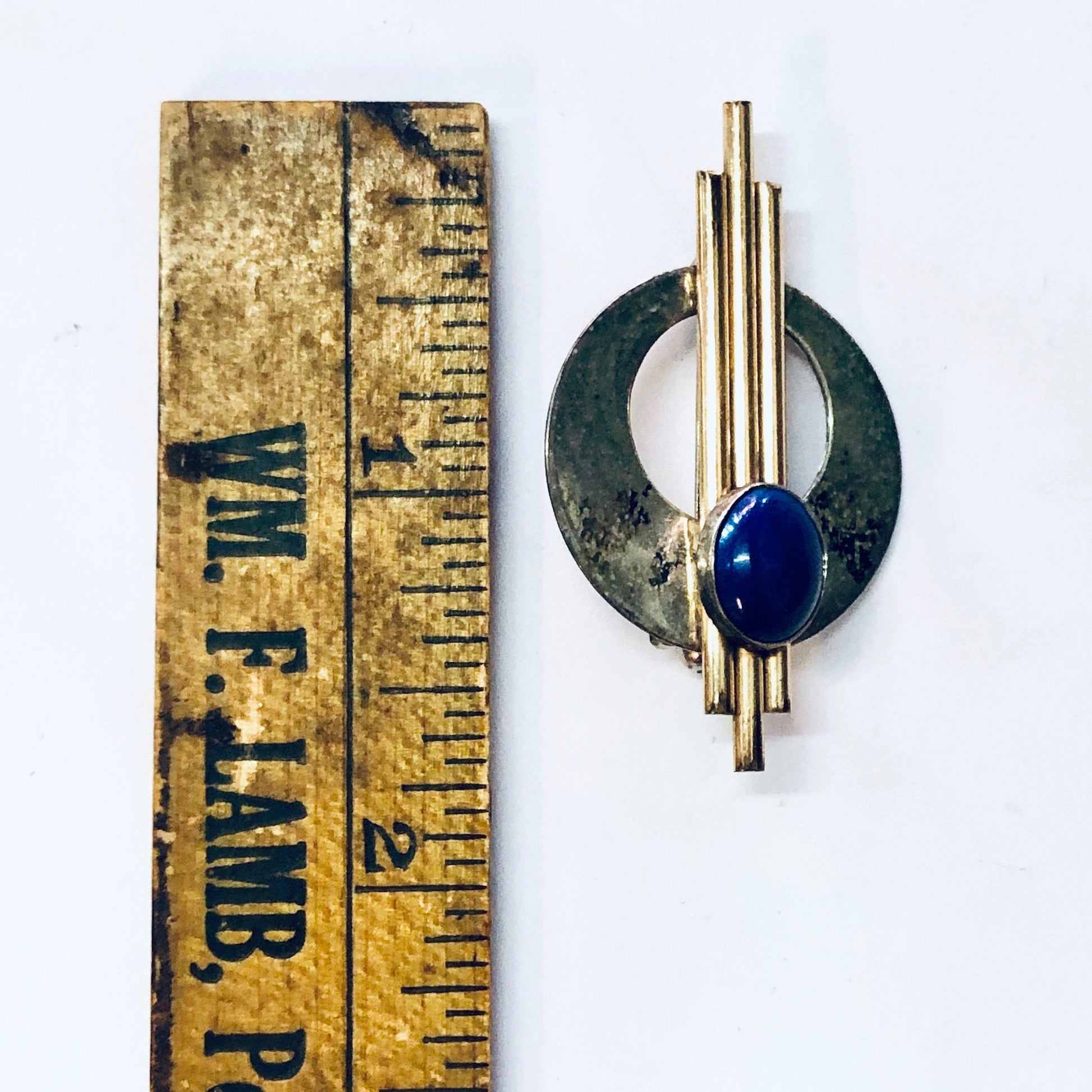 Vintage gold-filled ruler brooch with abstract design and blue stone cabochon set in silver minimalist circular frame