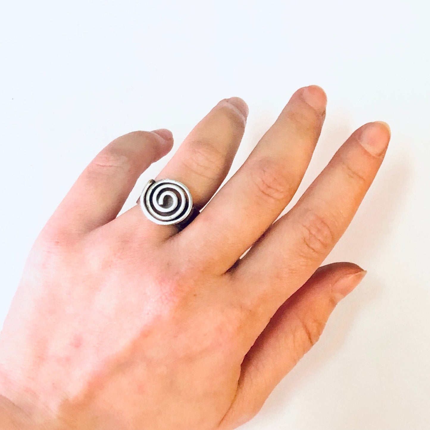 Vintage silver swirl design ring on hand, thick band modernist bohemian statement jewelry