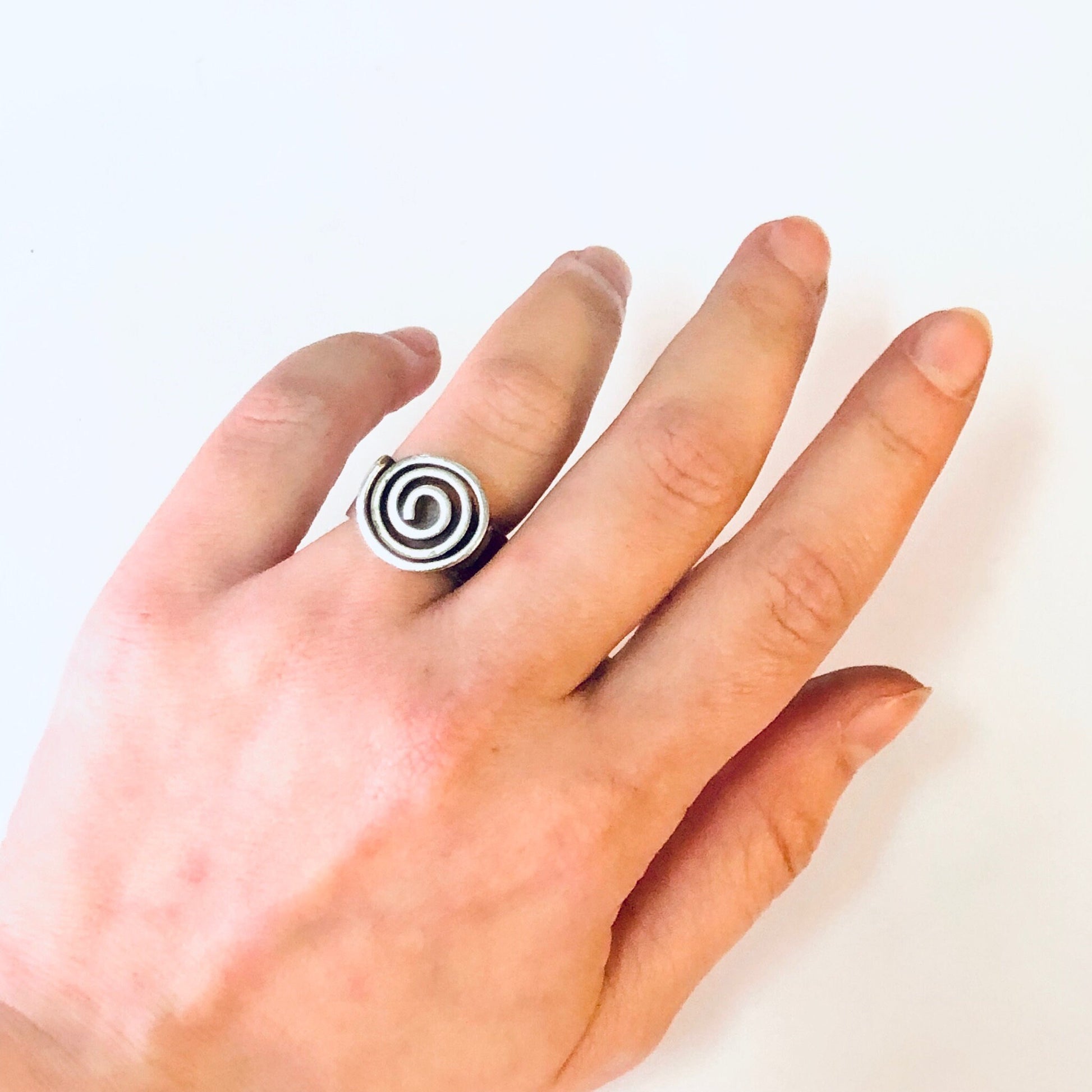 Vintage silver swirl design ring on hand, thick band modernist bohemian statement jewelry