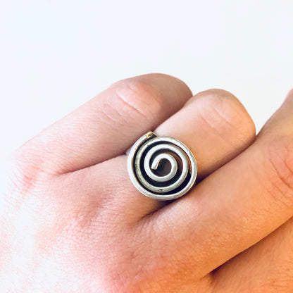 Vintage silver swirl design statement ring on finger, thick band bohemian modernist jewelry