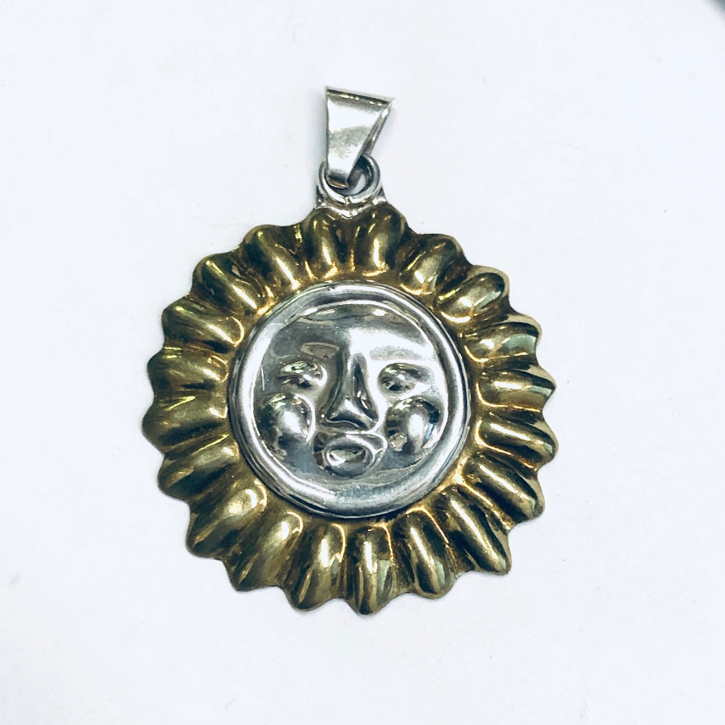 Vintage silver sun pendant featuring a smiling face design accented with gold-toned rays, suitable for use as a charm or necklace accent piece.