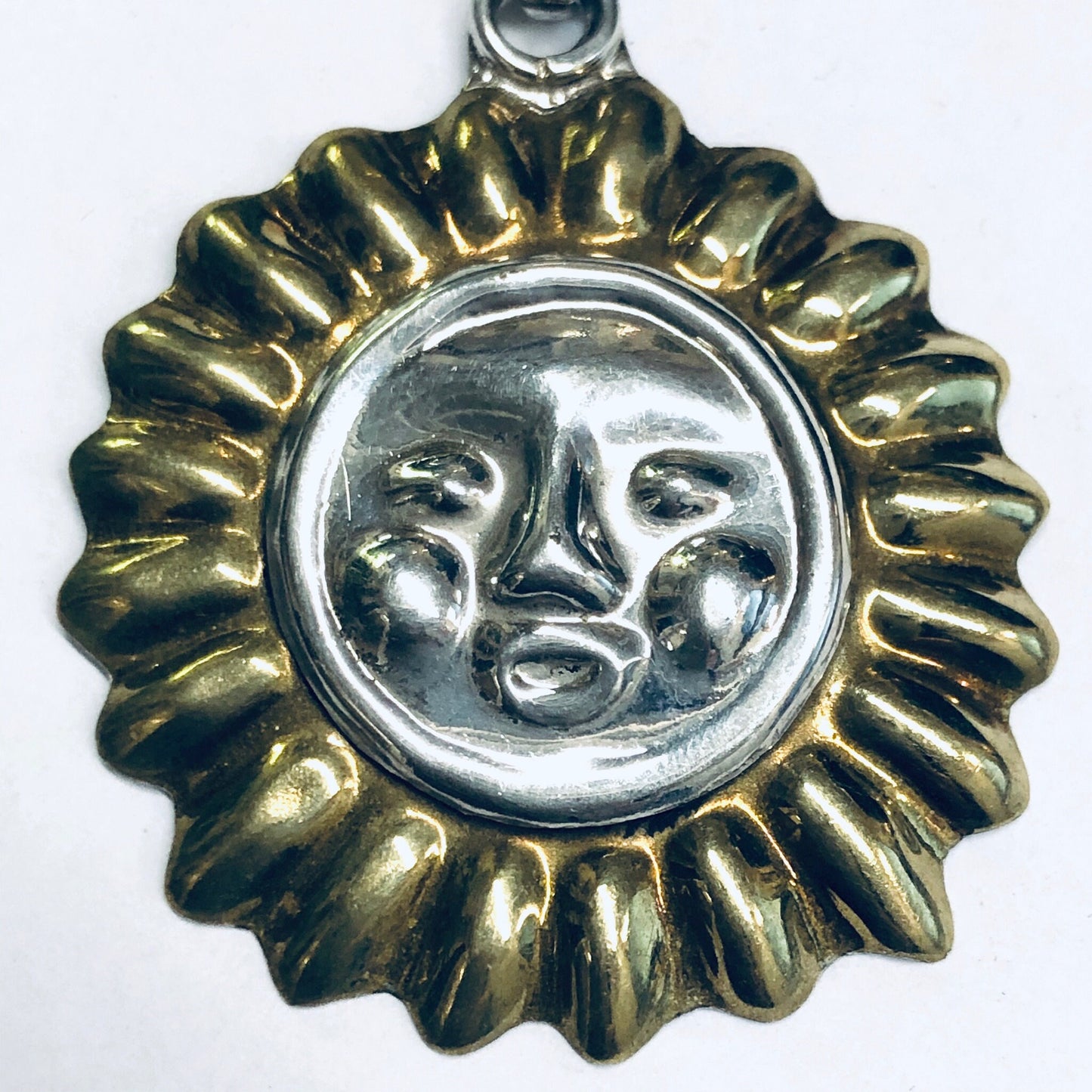 Vintage silver sun pendant charm with gold accents and embossed face design, round shape suitable for necklace jewelry.