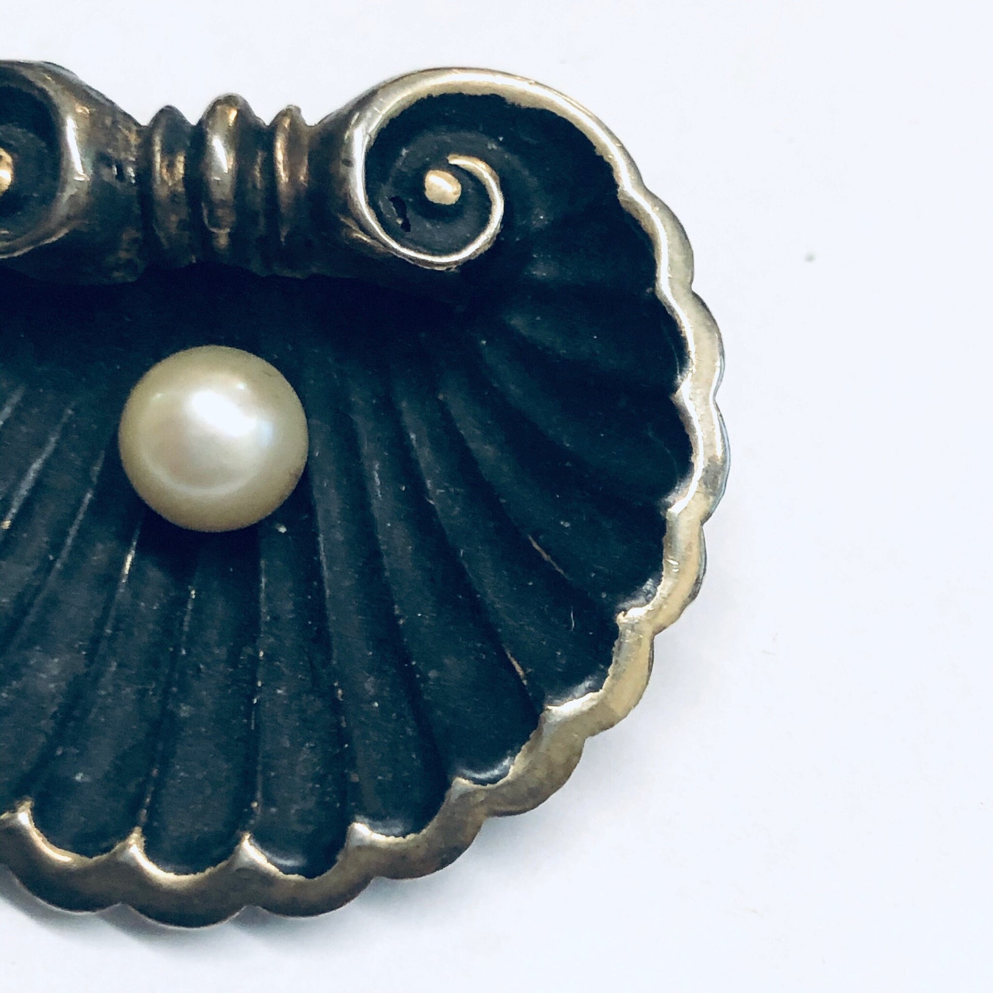 Antique scallop shell brooch with central pearl accent, crafted in matte black and gold-washed metal in an Art Nouveau style, designed by Karen Lynne Sterling.