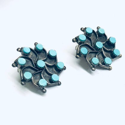 Vintage turquoise and silver star-shaped clip-on earrings on white background