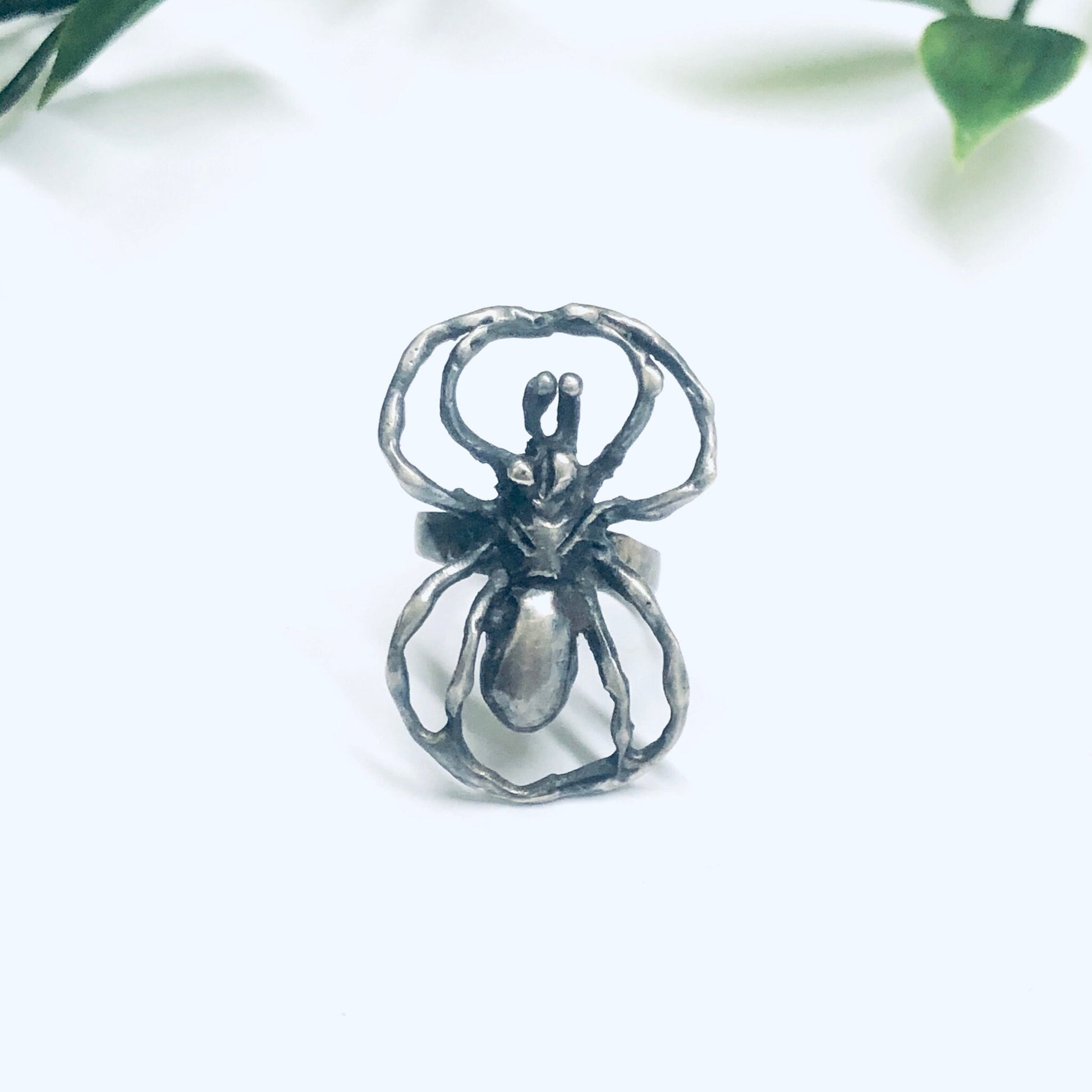 Silver spider ring crafted in vintage style, featuring a large, intricate spider design. The ring serves as a bold statement piece of insect-inspired jewelry with a spooky, eye-catching aesthetic.