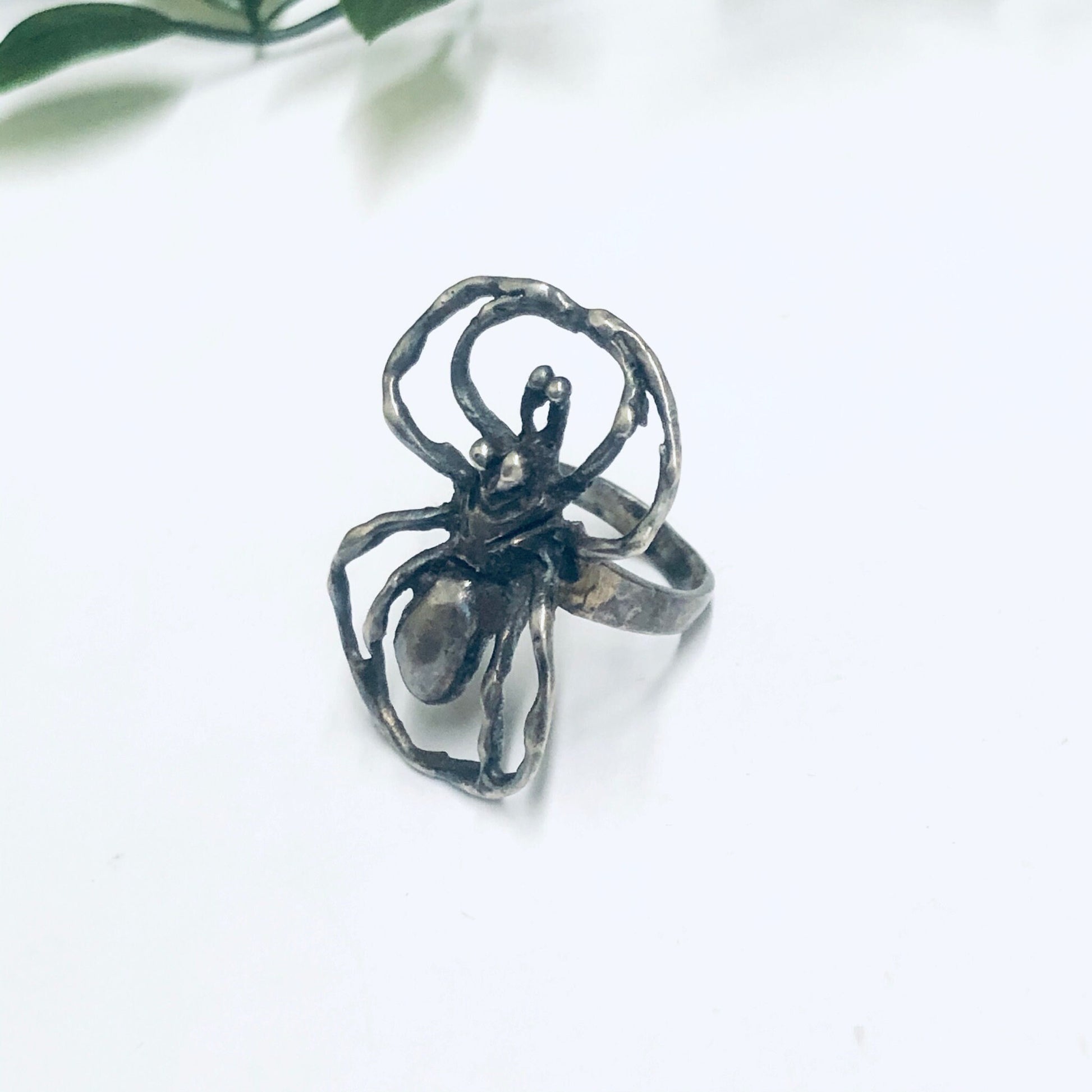 Vintage silver spider ring featuring a large, intricate spider design. Unique statement ring perfect for insect jewelry lovers or those who appreciate a spooky, eye-catching accessory.