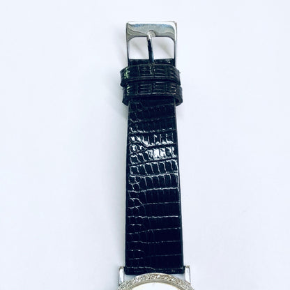 Vintage Longines mystery dial watch with 18K white gold case, diamond bezel, and blue leather strap