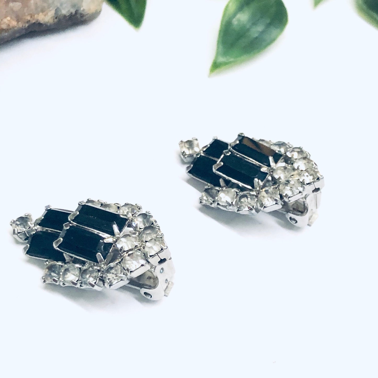 Vintage-inspired rhinestone clip-on earrings in black and silver tones, showcasing an elegant retro design with sparkling crystals, perfect for adding a touch of glamour to any outfit without the need for pierced ears.