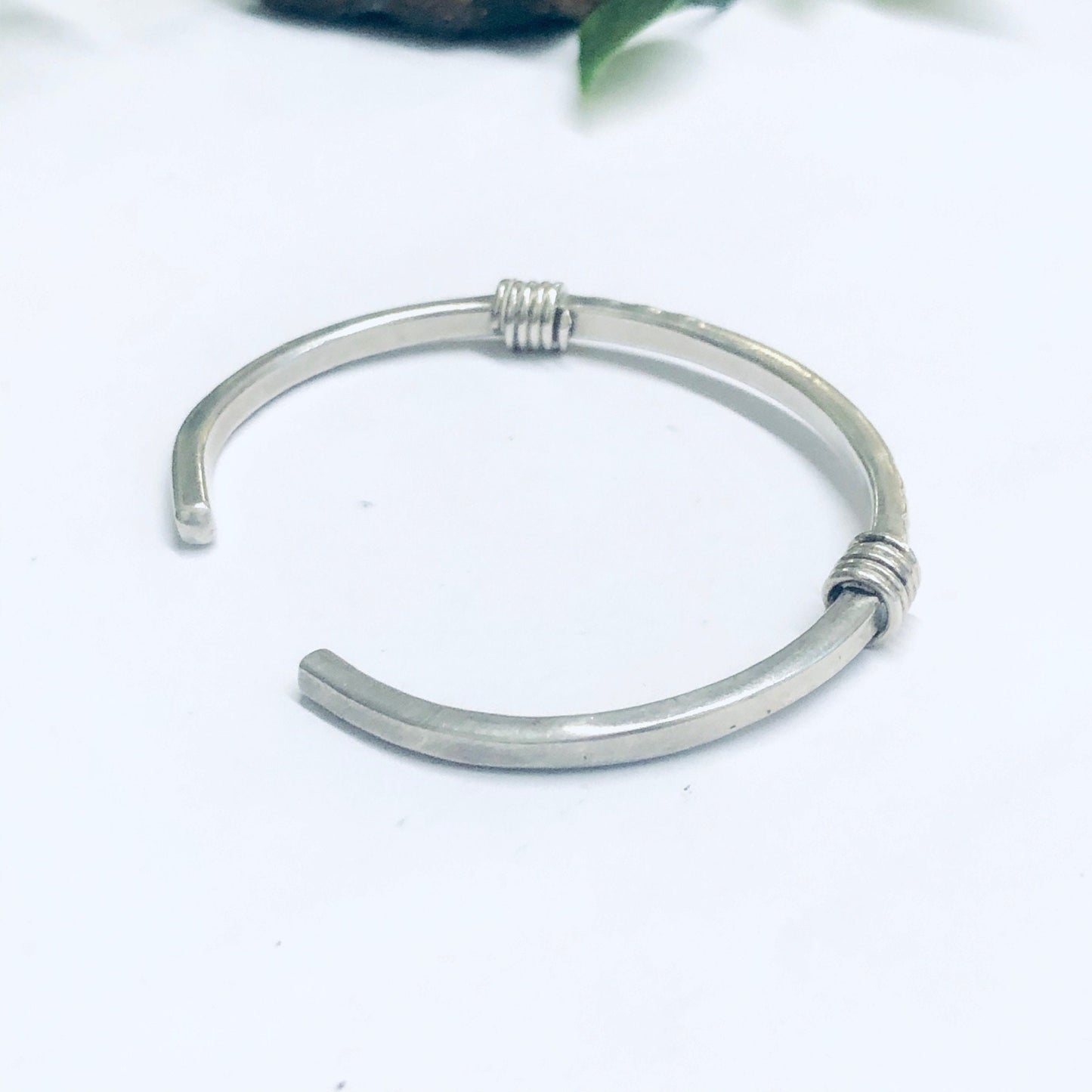 Vintage thin silver cuff bracelet on white background