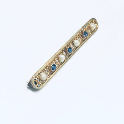 Vintage 14K yellow gold bar pin featuring lattice design with pearls and faceted blue gemstones, measuring 1 3/4 inches long, suitable as a cute jacket pin or brooch.