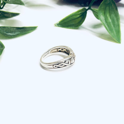 Solvar Sterling Silver Claddagh Ring with heart-shaped band set among green leaves