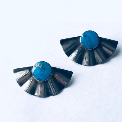 Vintage silver fan-shaped earrings with round blue gemstones, designed for pierced ears