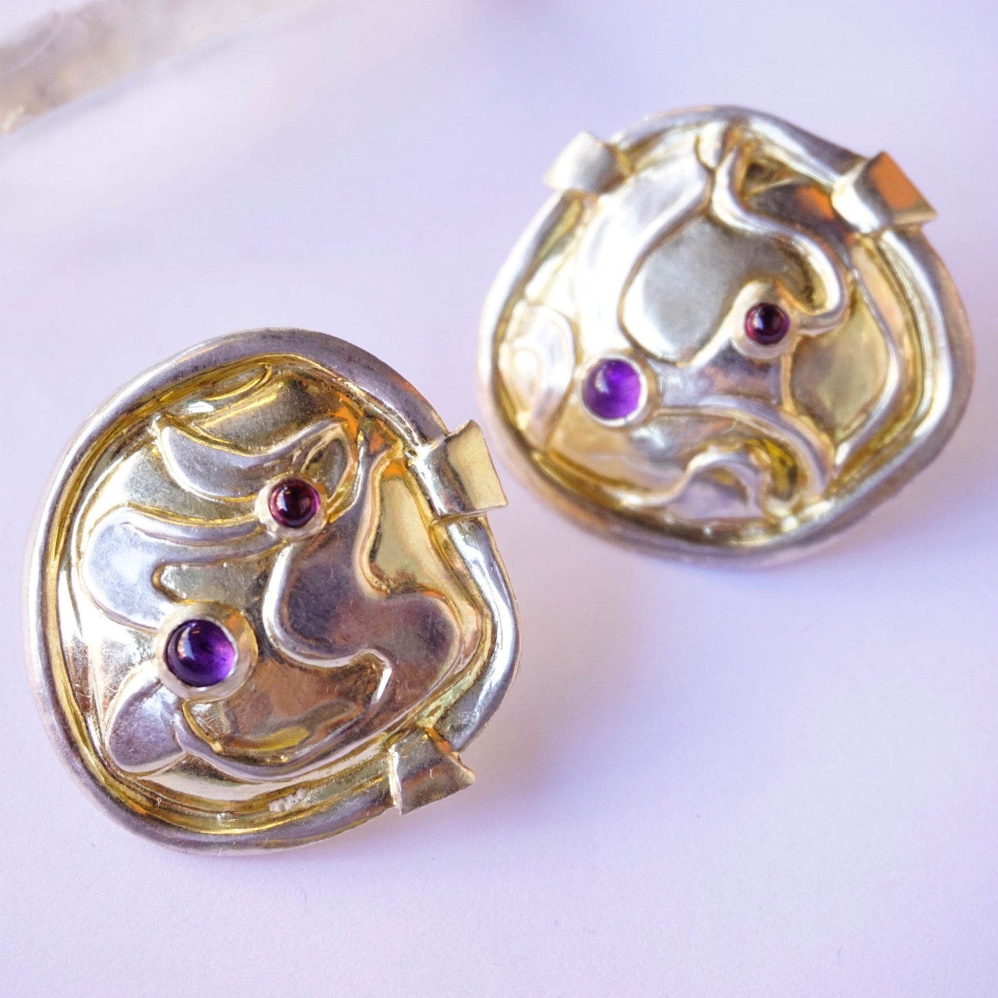 Vintage William and Shellie sterling silver abstract modernist earrings featuring small amethyst gemstones set in swirling, organic forms.