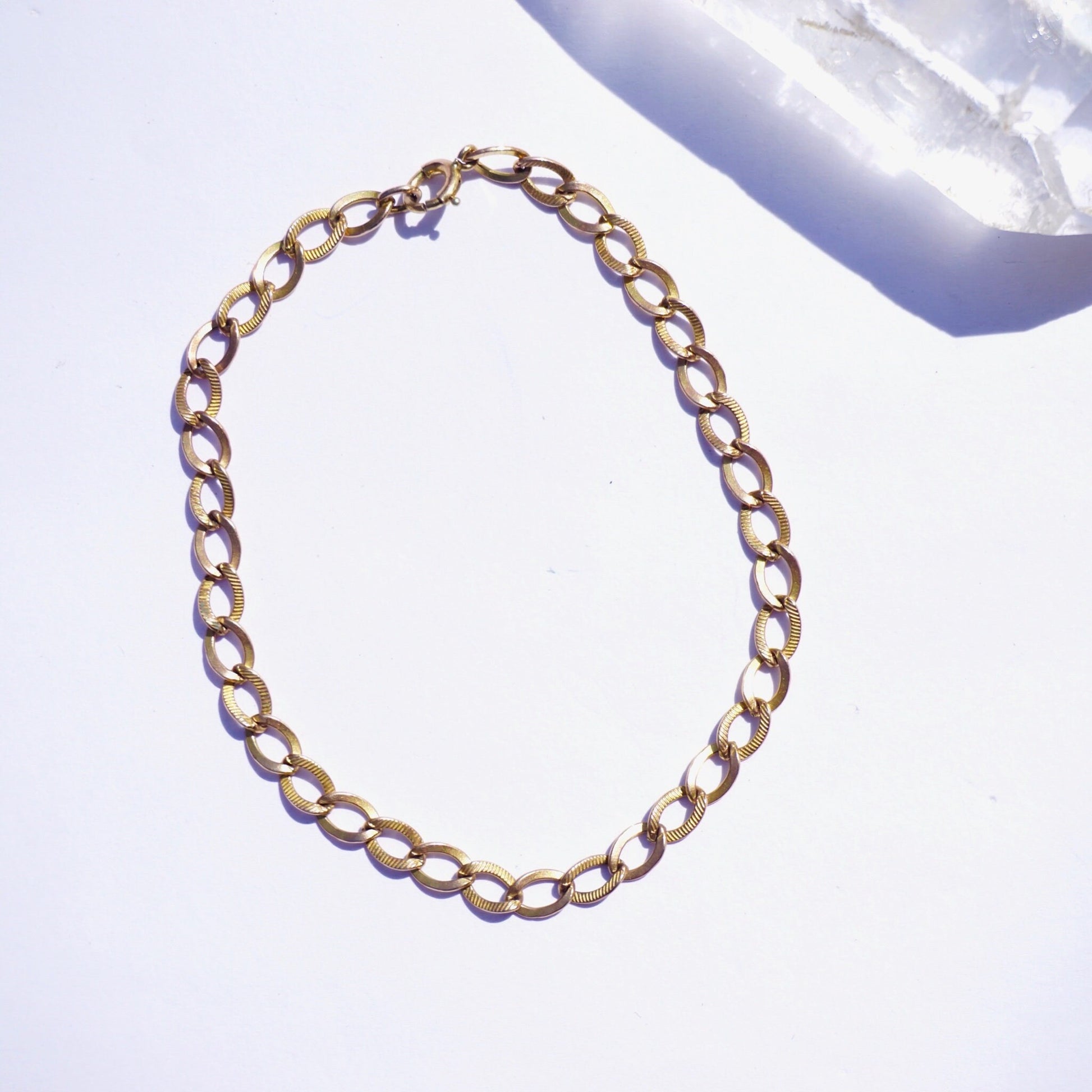 Vintage 10K gold Cuban chain bracelet, delicate 7 inch minimalist gold chain bracelet on white background