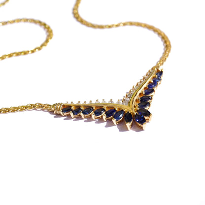 Vintage 14k gold sapphire and diamond choker necklace featuring an elegant chevron design with alternating blue sapphire and white diamond gemstones set in a delicate gold chain.