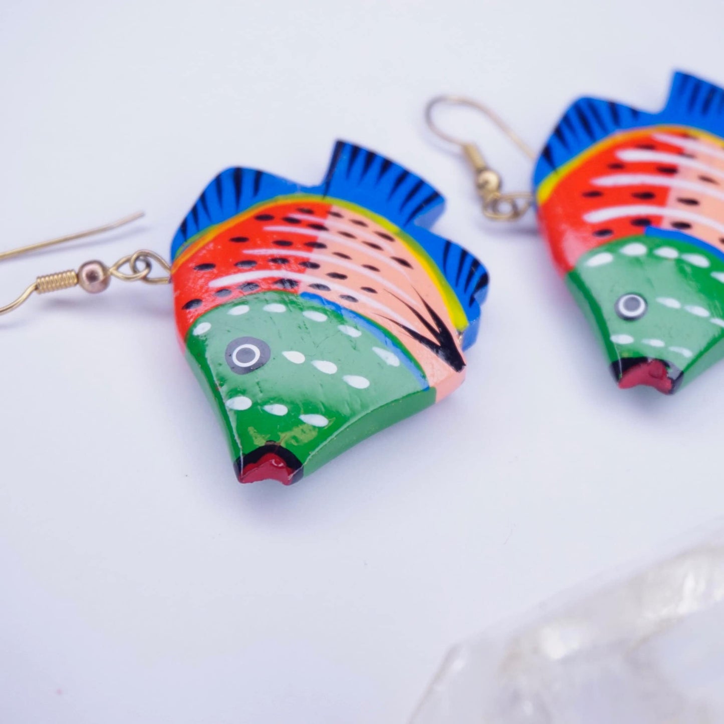 Colorful vintage wood carved fish dangle earrings with vibrant blue, red, and green painting on a white background, handmade wooden statement jewelry.