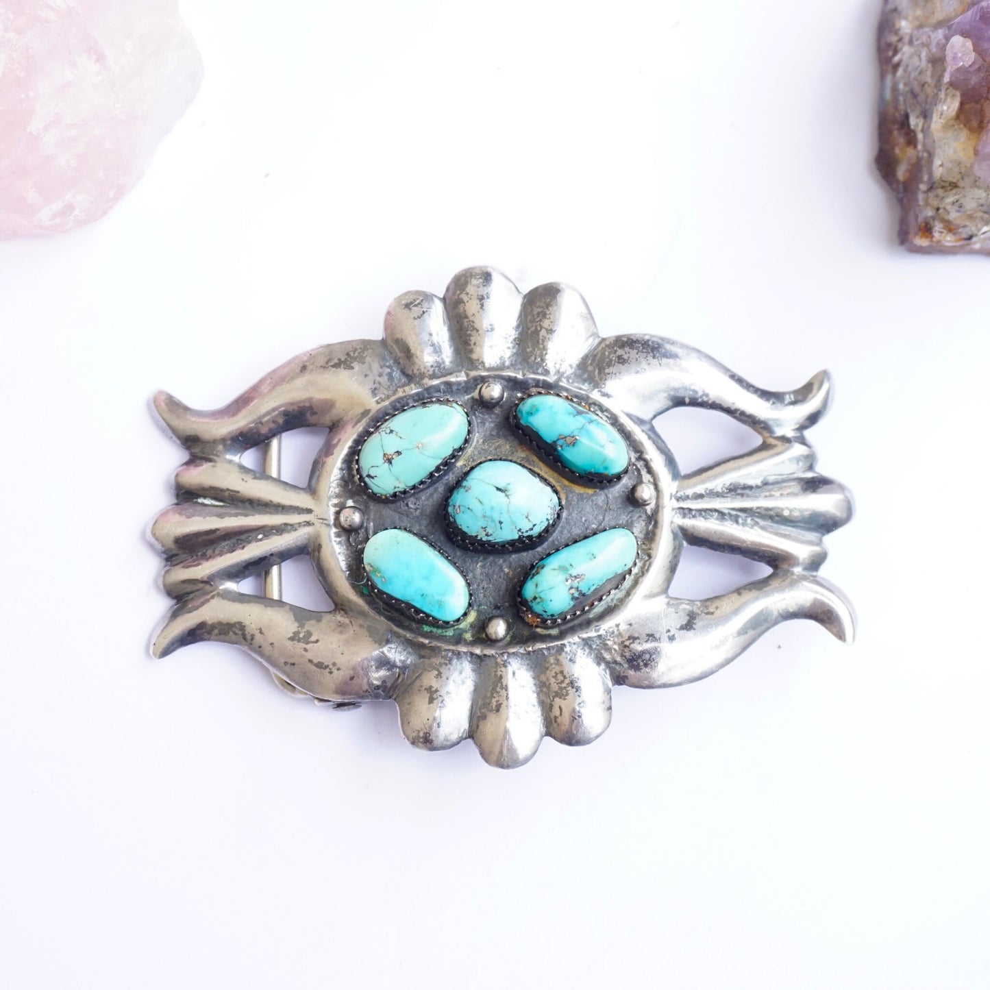 Vintage Navajo sterling silver belt buckle with multiple turquoise stones set in an oval design, showcasing intricate metalwork in a traditional Native American style from the old pawn era.