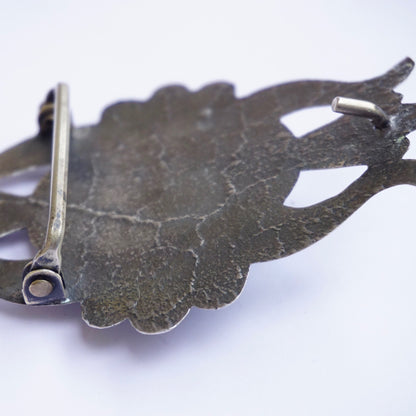 Vintage Navajo sterling silver turquoise belt buckle featuring multiple oval turquoise stones set in an ornate, hand-stamped silver leaf design against a white background.