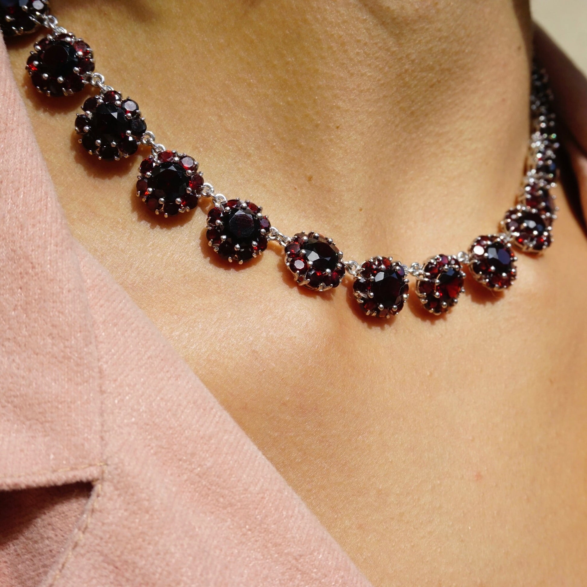 Vintage sterling silver garnet glass stone choker necklace with beautiful deep red stones set in an intricate beaded collar design, showcasing the stunning contrast between the gleaming silver and rich garnet hues.