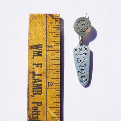 Vintage sterling silver dangle stud earrings with abstract swirl design, shown alongside a ruler for scale.