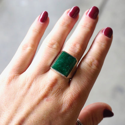 Vintage sterling silver ring with square green druzy quartz stone on a hand with dark red nail polish, showing the ring from different angles against a light background.