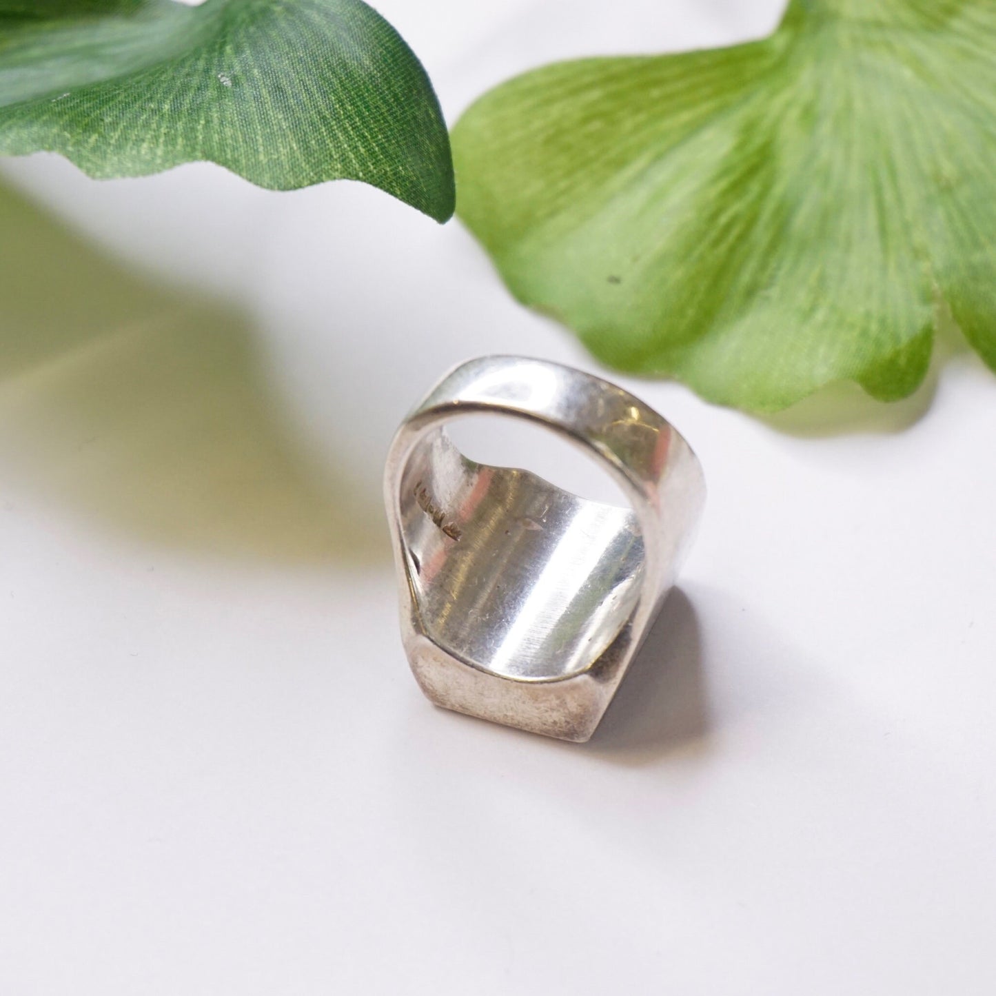 Vintage sterling silver ring with a square green druzy quartz stone, handcrafted in Mexico. The ring showcases a polished silver band and bezel-set green druzy quartz gemstone.