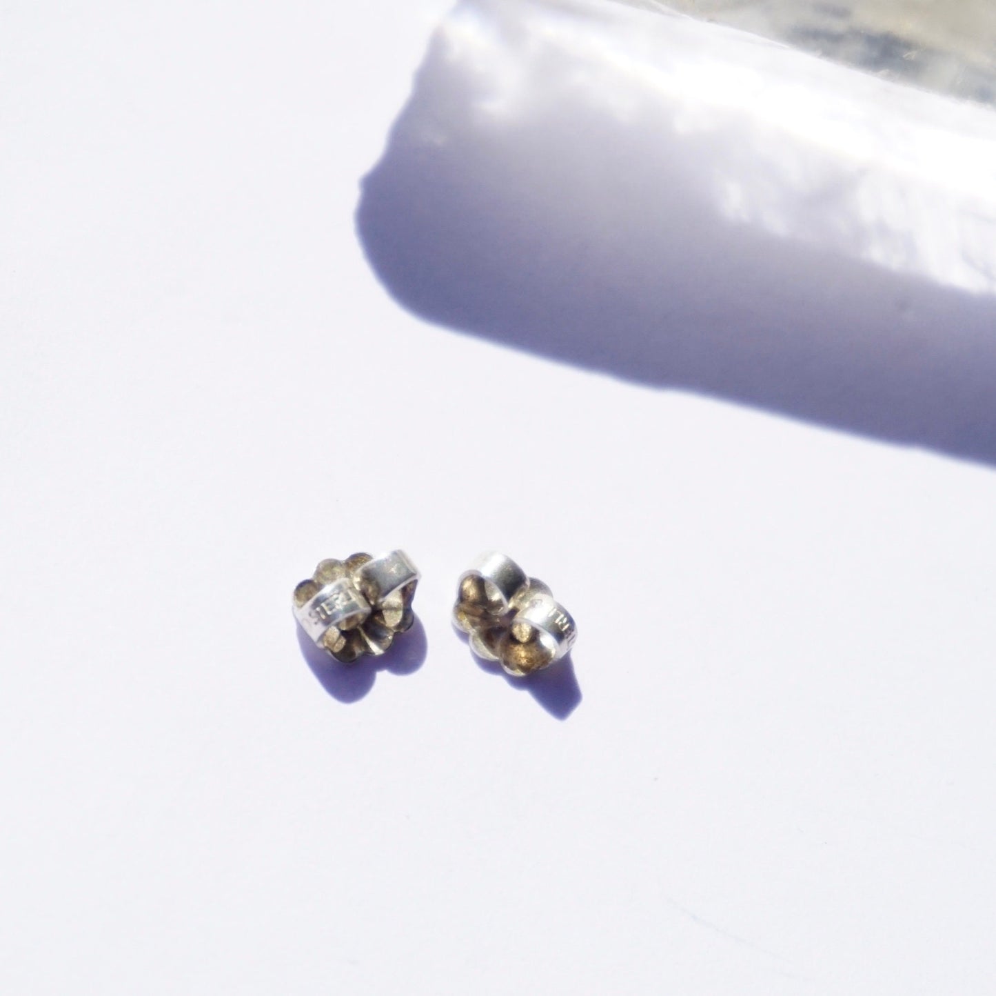 Vintage lapis lazuli and sterling silver stud earrings on white background